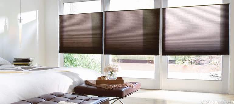 Contemporary Boston bedroom with high ceiling windows and vertical honeycomb shades.