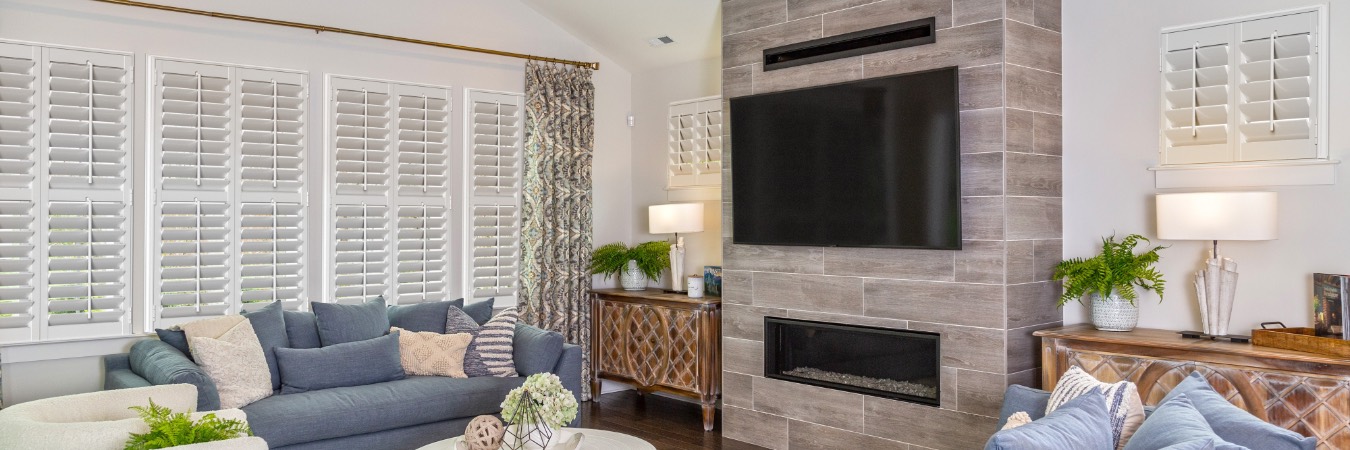 Interior shutters in Brookline family room with fireplace