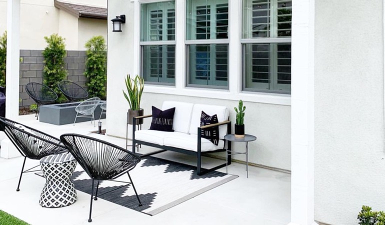 Spending a few hours weeding and mulching can help give you a backyard oasis. Backyard with plantation window treatments