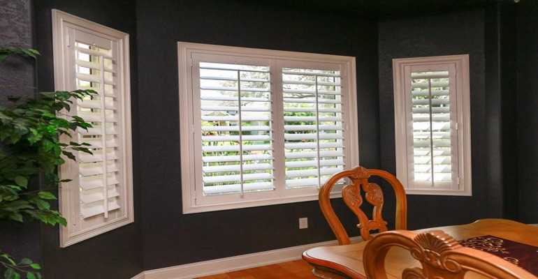 Crisp Plantation Shutters In Dark Green Dining Room