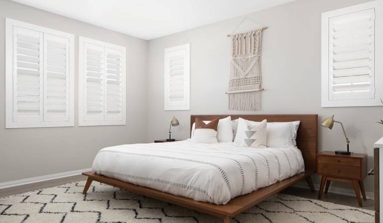 Open shutter louvers will help any Boston room feel larger. Plantation shutters in a model home bedroom.