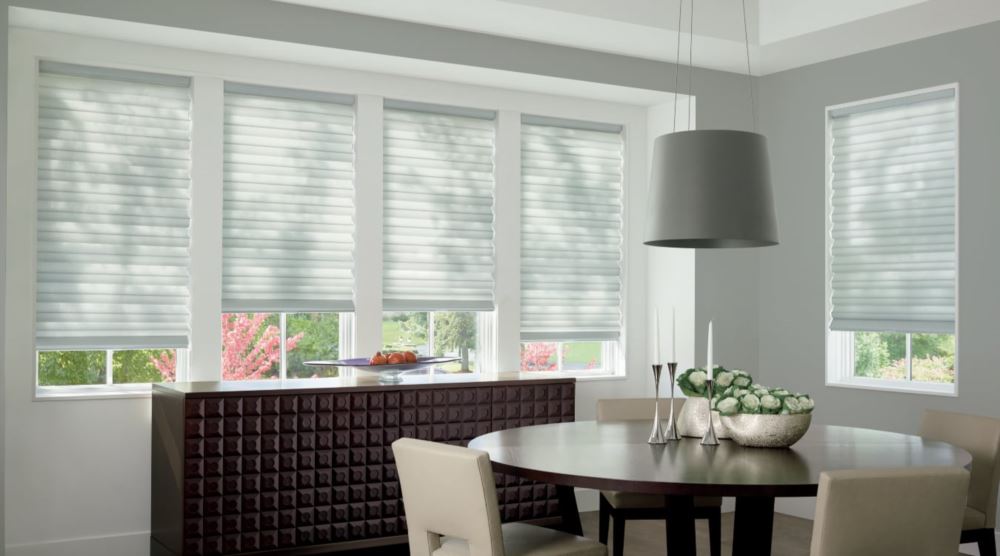 Custom cordless roller shades have a clean look and are appropriate for any room. Cordless motorized shades in a Boston dining room