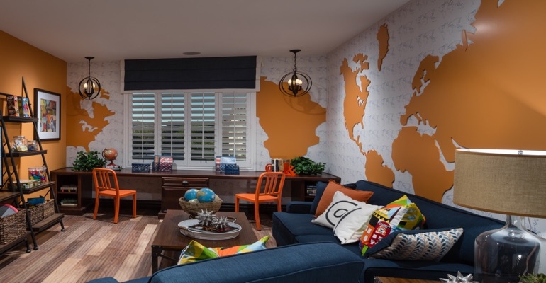 Plantation shutters are an ideal window treatment for a learning area. Family room with wall map and plantation shutters
