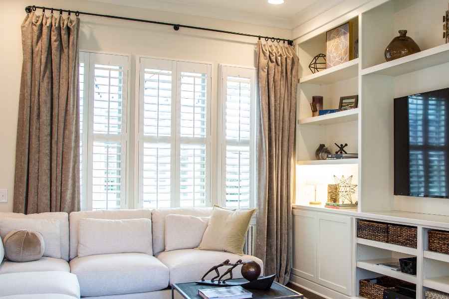 Install sun-resistant Polywood shutters in Boston. Shutters in a living room