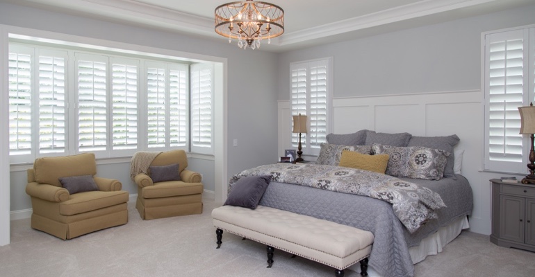 interior shutters offer subtle style. Plantation shutters in Boston bedroom.