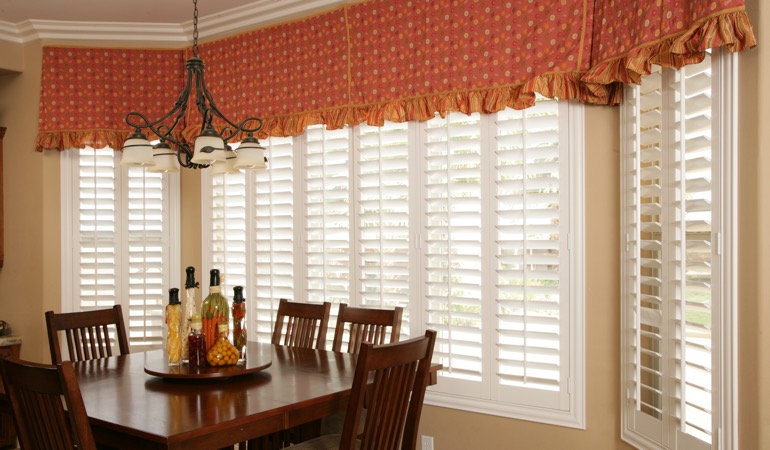 Decorative accents, drapes, and curtains may not offer the simplicity you are going for. Plantation shutters in Boston dining room.