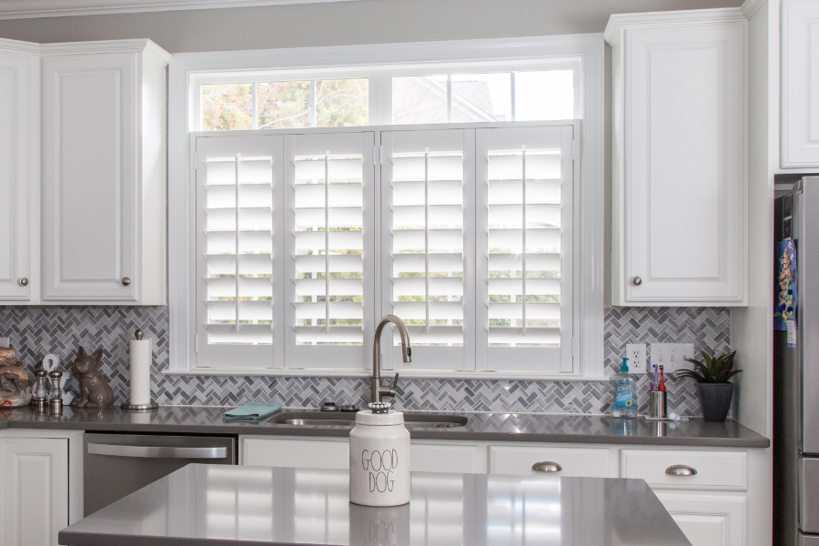 Classic Polywood interior shutters in Boston are moisture-resistant. White Polywood shutters above a kitchen sink