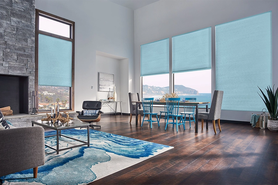 Smart motorized window shades are perfect on tall windows in your Boston home. Blue motorized shades on tall living room windows